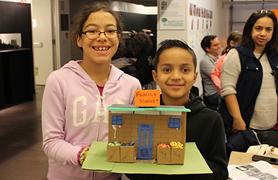 Siblings show off their Family Market. Photo: Center for Architecture.