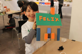 Child holding model doghouse