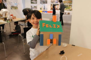 Child holding model doghouse