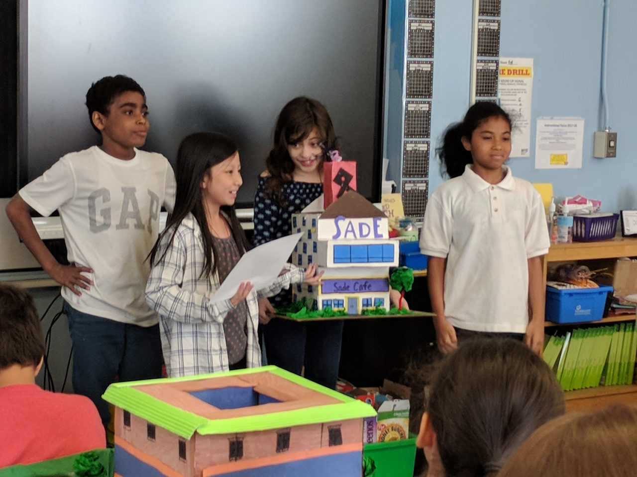 PS 206K: Fifth grade students present the mixed-use building (café and apartments) they proposed for a nearby empty lot. In this six-session program led by Design Educator Kimberly Tate, students began by looking at the architecture in their neighborhood, then worked in teams to design a building they felt would best fill a neighborhood need. 