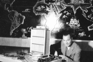 Architect Sayed Karim posing at his home office with a model of his unbuilt Hotel Nefertiti, circa 1960.