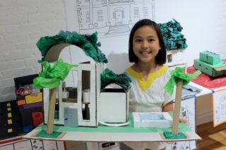 Child with building model