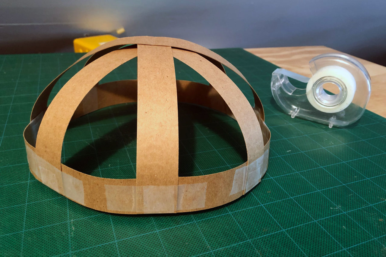 Continue adding strips until the dome becomes strong and snug enough to fit on your head.