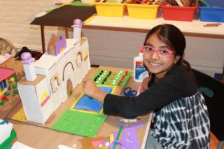 Child with building model