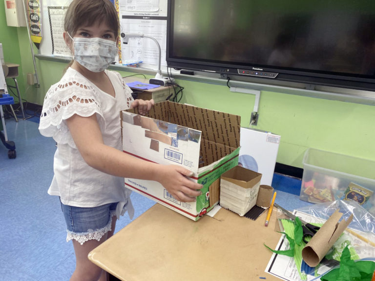 Photo of student presenting green roof design.