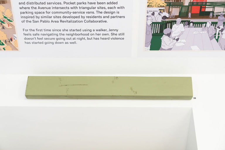 Khaki green two-by-four wood stud laid out horizontally on a surface.