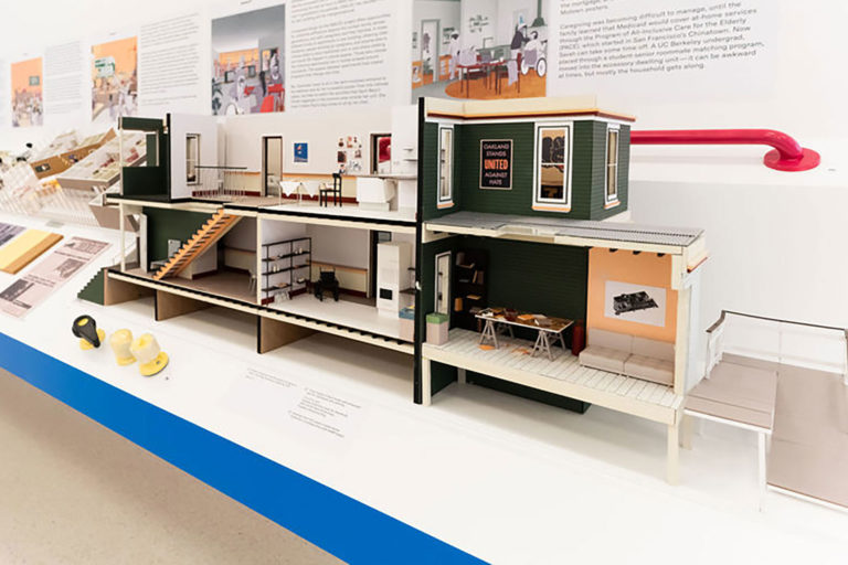 Three-dimensional model of the interior of a two-story house that is accessible via a ramp on the far-right end and has a stairlift on the main staircase.