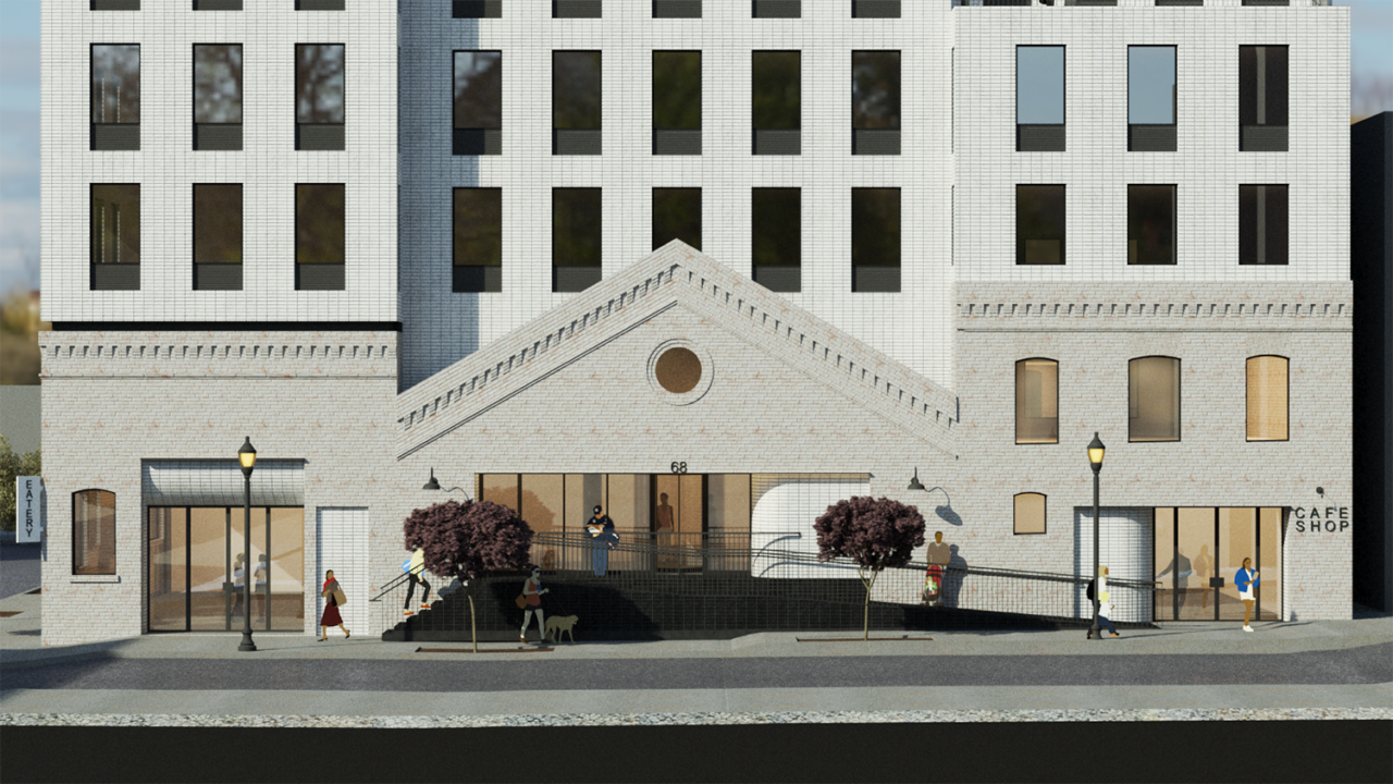 Multi-story white apartment building from ground level with a pedimented entrance