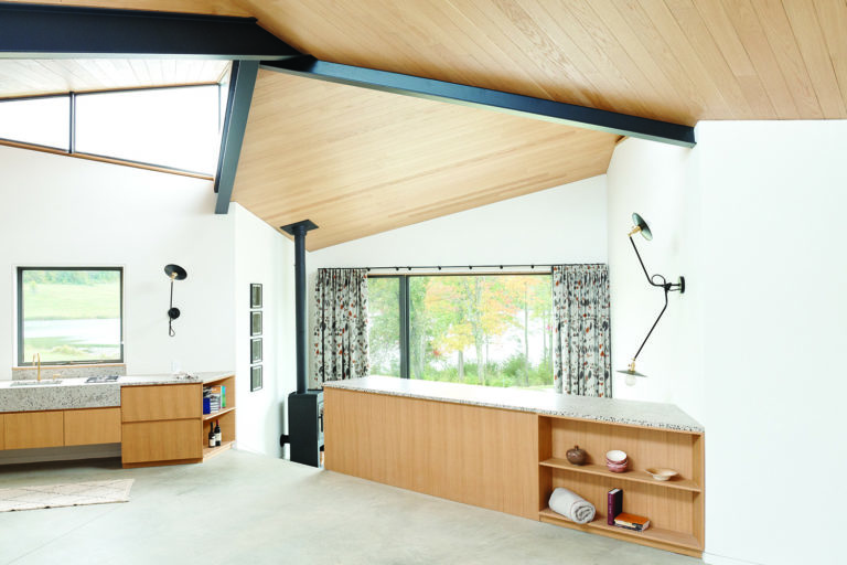 Residential interior with slanted wooden roof and skylight