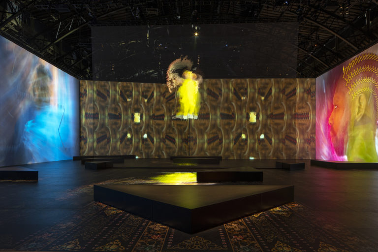 Hollogram in a gallery space at the Park Avenue Armory with ornate custom vinyl walls