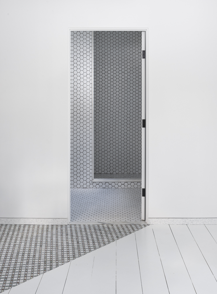 A view through doors, showing a series of tiles and materials