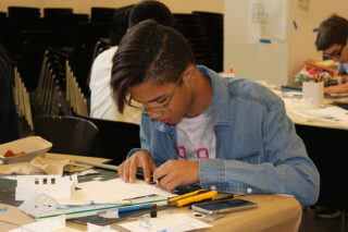 High school student working on scale building model
