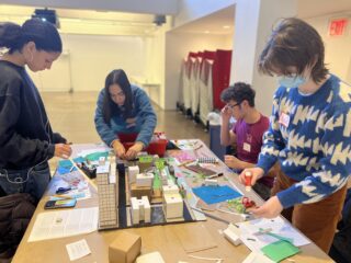 Group of four high school students working on a neighborhood model