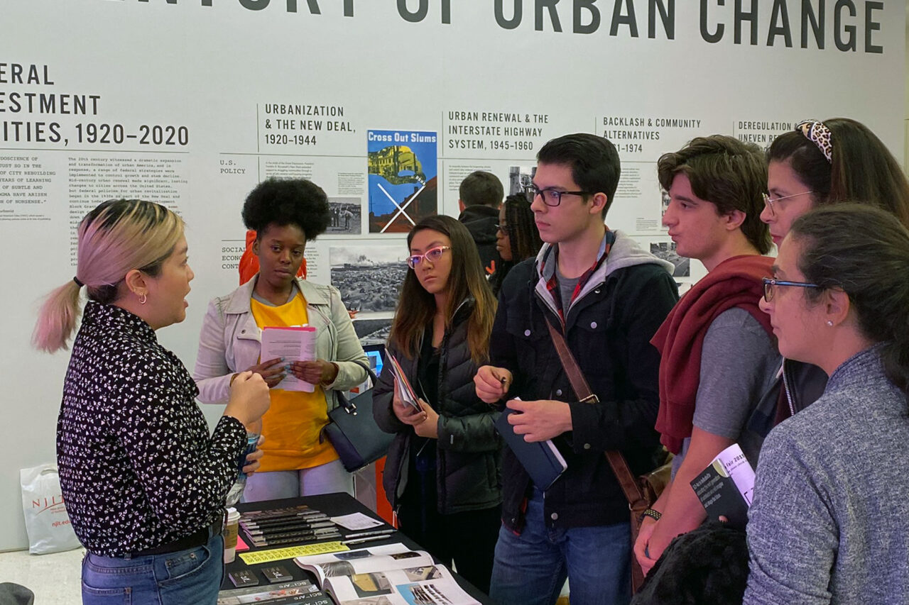 Group of high school students speaking with college representative.