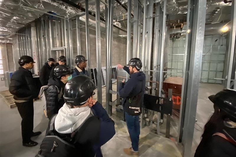 High school students and architects on a site visit at a construction site