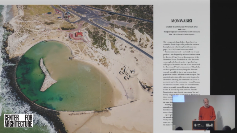 Presentation slide of a page of "Sea Pools" book with the author Chris-Romer Lee speaking at a podium.