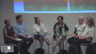 Six people sitting semicircular in front of an audience.