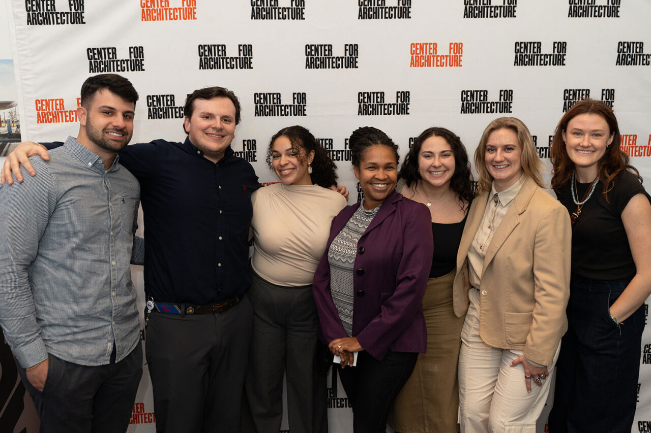 Group poses in front of Center for Architecture backdrop.
