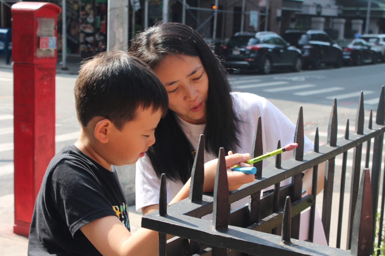 Mother and son sketching outside