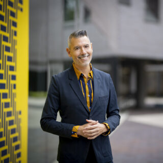 Dean Massey in front of the  College of Architecture and Urban Planning