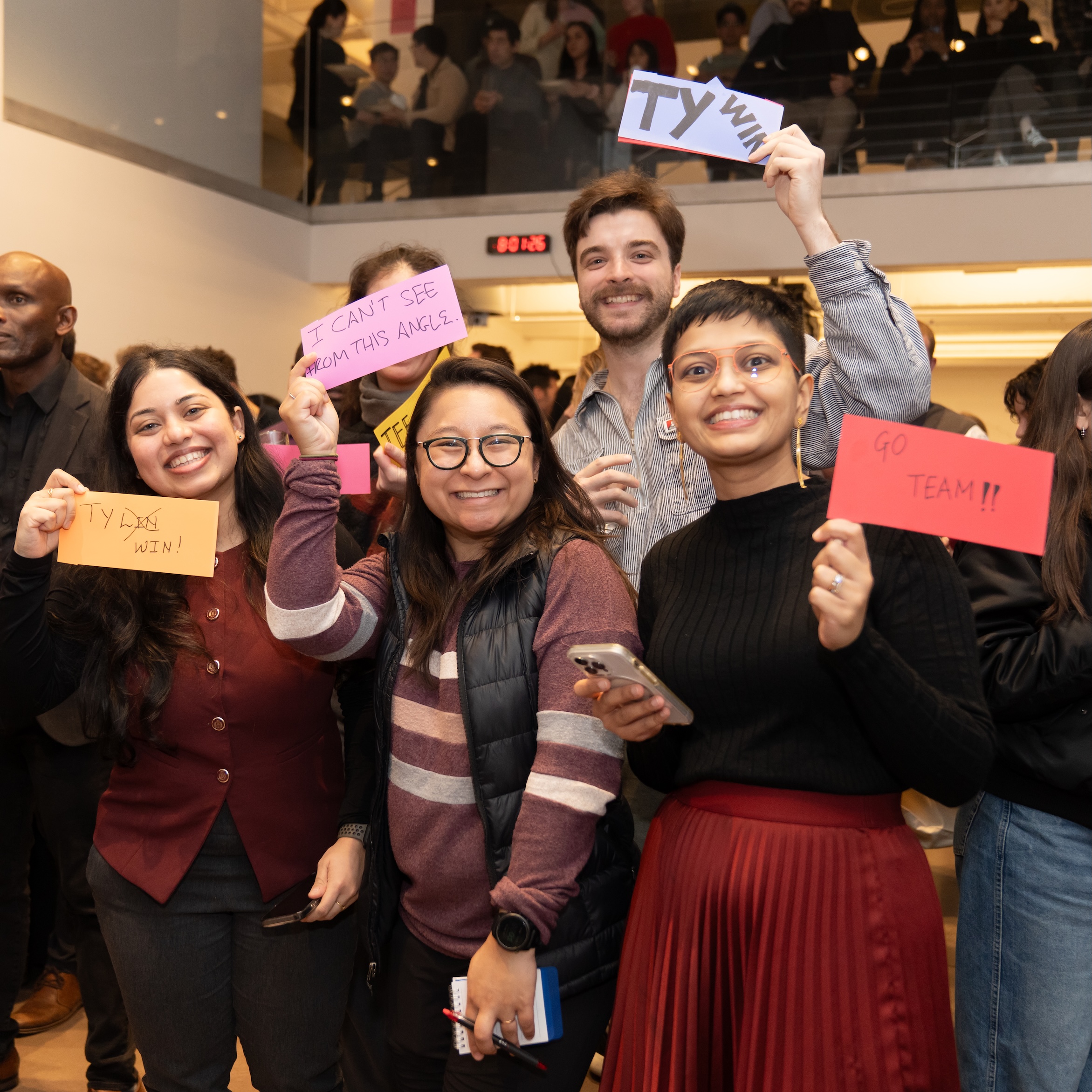 Guess-A-Sketch team TYLin holding signs and posing for the camera