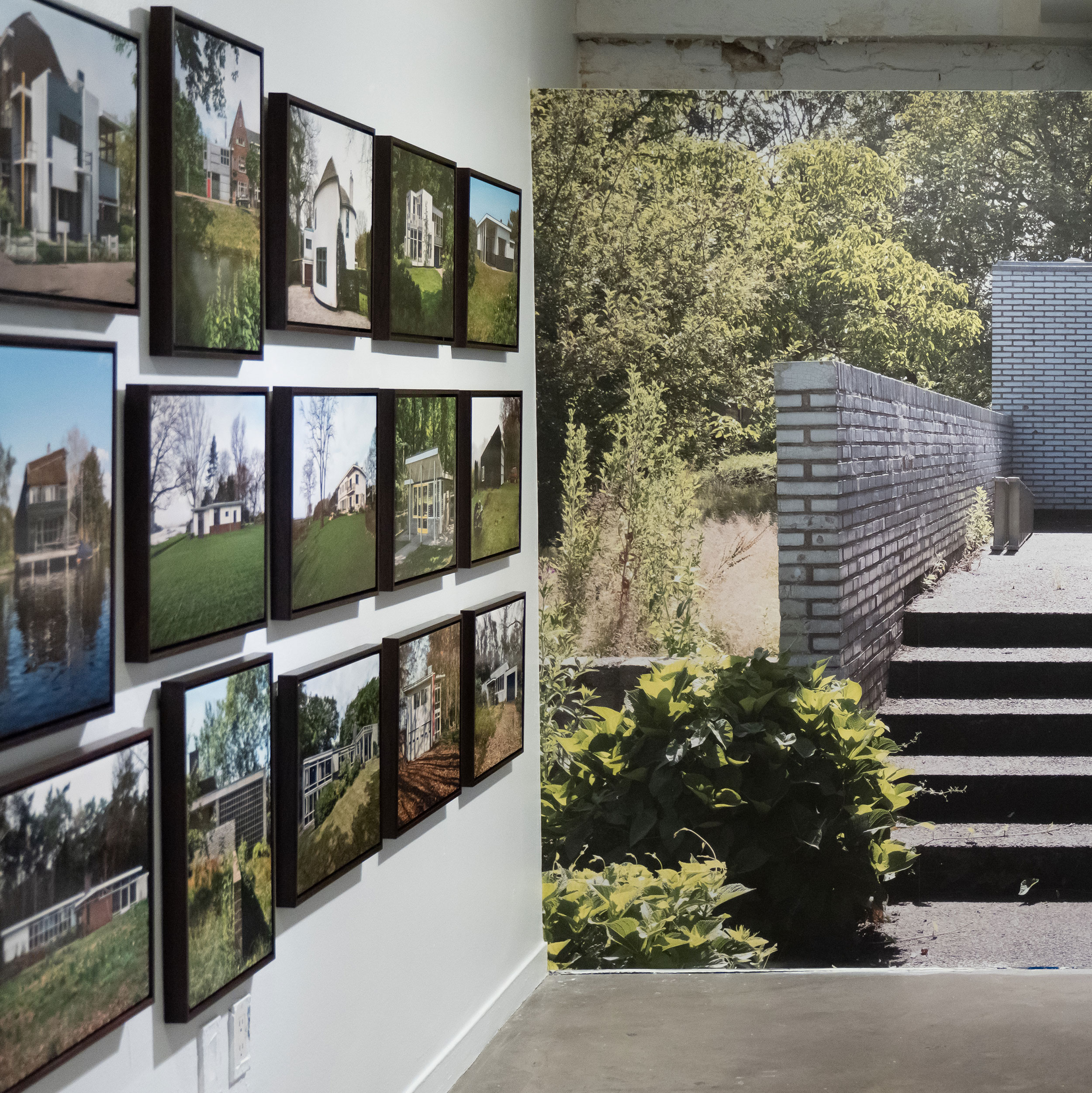 Closeup of a series of framed photography installed on a wall