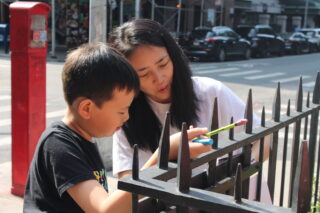 Parent and child drawing outside
