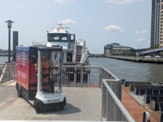 Image of a delivery cart and a boat